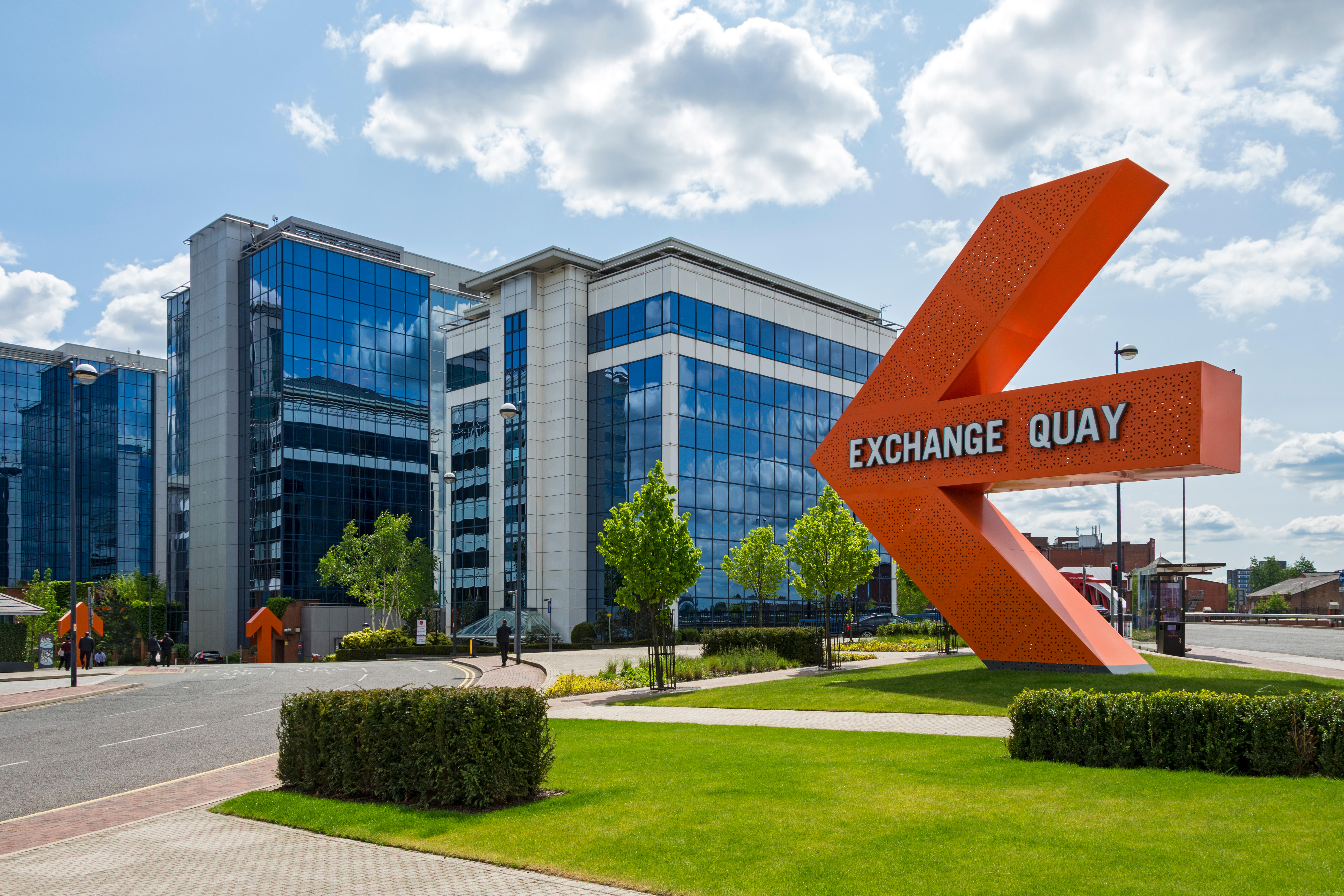 View of Exchange Quay, a commercial business district located in Salford. The image shows modern high rise office buildings.