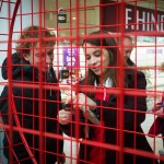 Woman attaches padlock to giant Valentine heart installation at Love Lock-In retail event, Cardiff