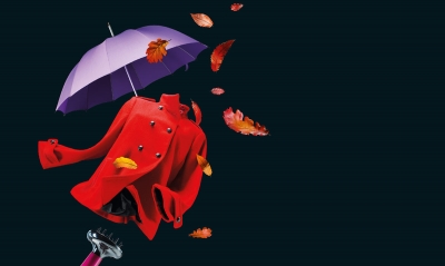 Autumn Fashion Fix event campaign logo shows fashion and beauty icons to suggest the autumn season. A red coat and autumn leaves blowi in the wind created by a hairdryer and there is a purple umbrella in the background.