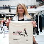 The experience economy - A woman at a live experiential fashion event taking place in a shopping mall, presents her goody-bag to camera.