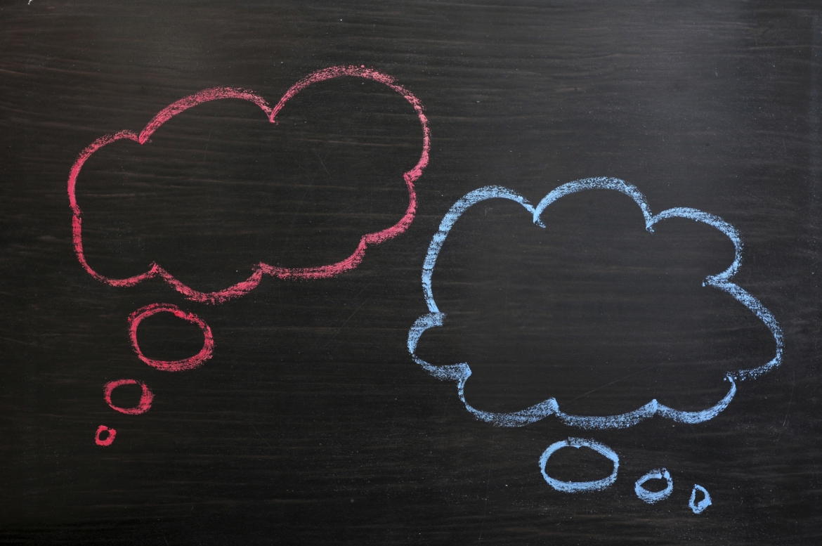 Chalk drawing of blank think bubbles on a blackboard background