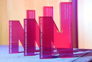 Close up picture of Northern Marketing Awards trophies lined up ion a table top.