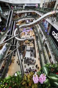 Retail-tainment - View from the 5th floor of the Printemps shopping centre, Shanghai, showing the giant stainless steel slide that delivers customers to the ground floor in 16 seconds.