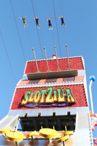 Retail-tainment - Four people riding the Slotzilla zipline above Fremont Street, a retail shopping and entertainment area of Las Vegas.